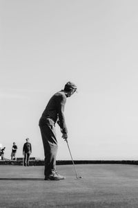 Golfer lining up their put.